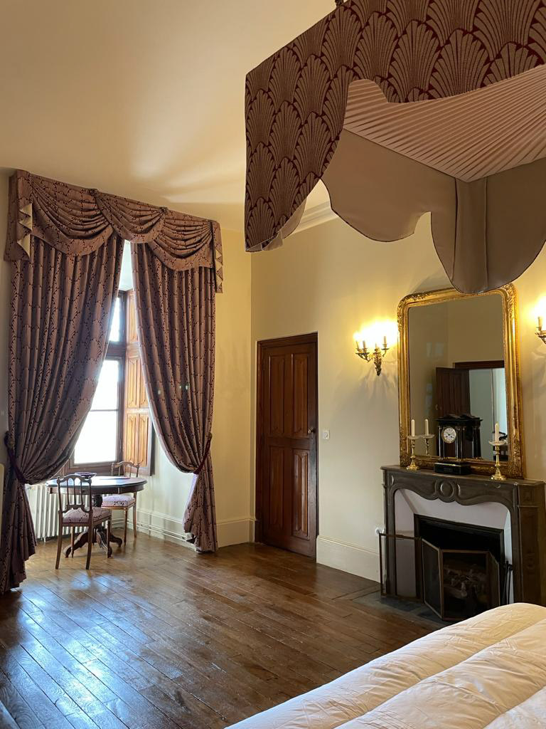 Château d&#039;Ainay-le-Vieil, the guest rooms, the Empire Room, view on the double bed with canopy and fireplace